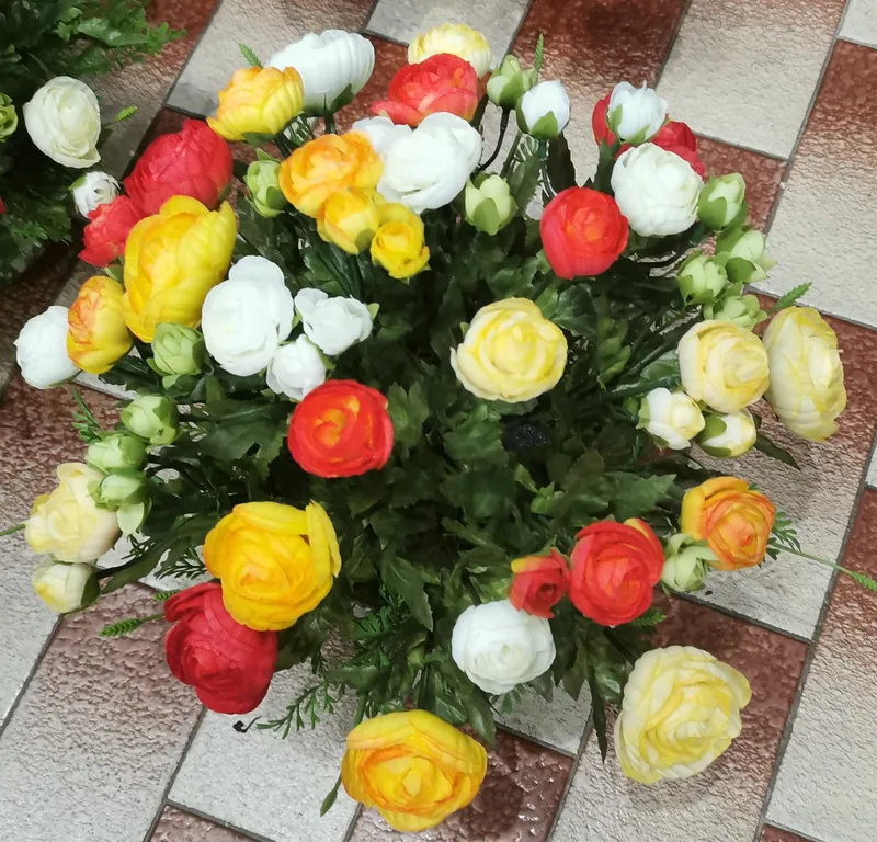 Arranjo de flores artificiais com ranúnculos amarelos, brancos e cor de laranja